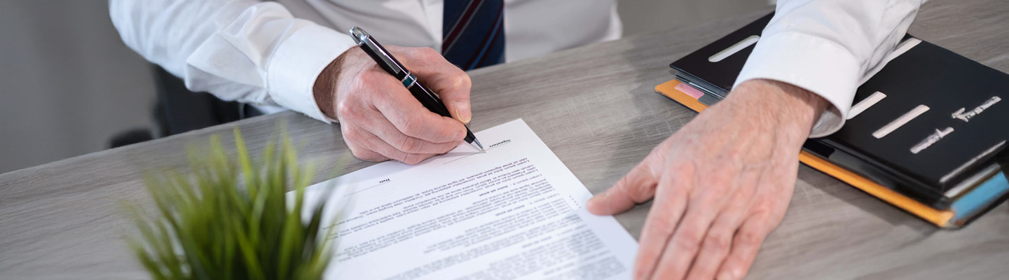 Hand of businessman signing a document