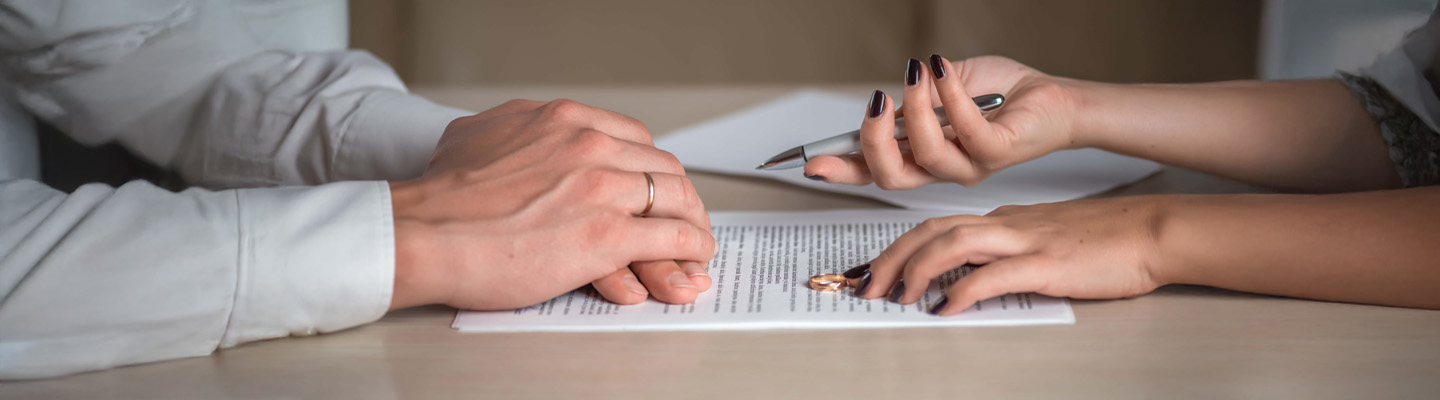 Wife and husband signing divorce documents woman returning wedding ring