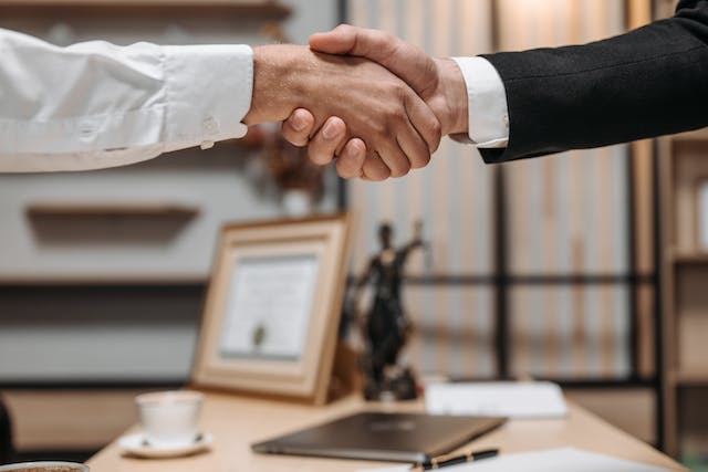 people shaking hands in law office