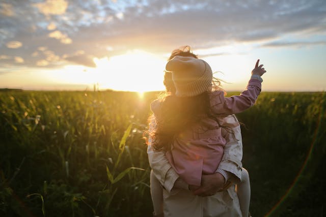 parent holding child outside