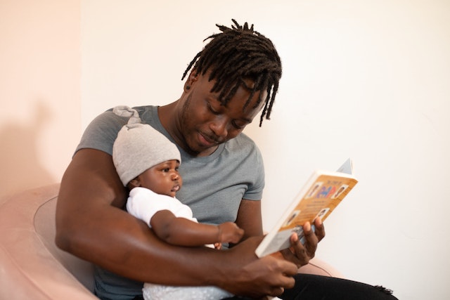dad reading book to baby
