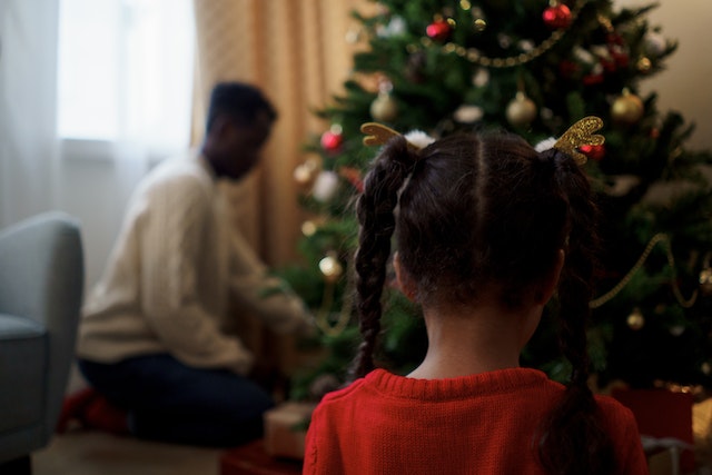 dad and child by christmas tree