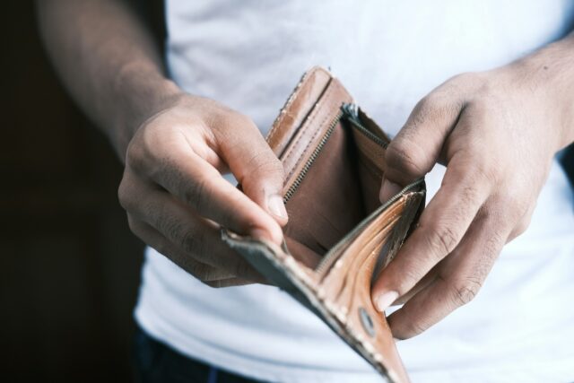 man holding open wallet